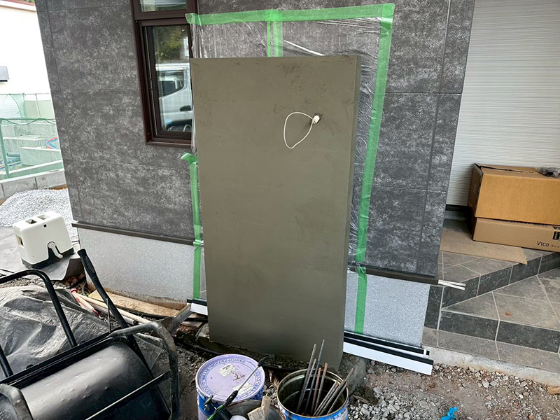 建物の外壁を塗り壁材で汚さないよう、背後に厳重な養生(マスキング)を施します